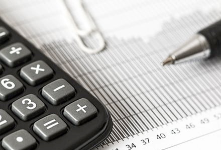 Calculator, pen, paperclip and paper