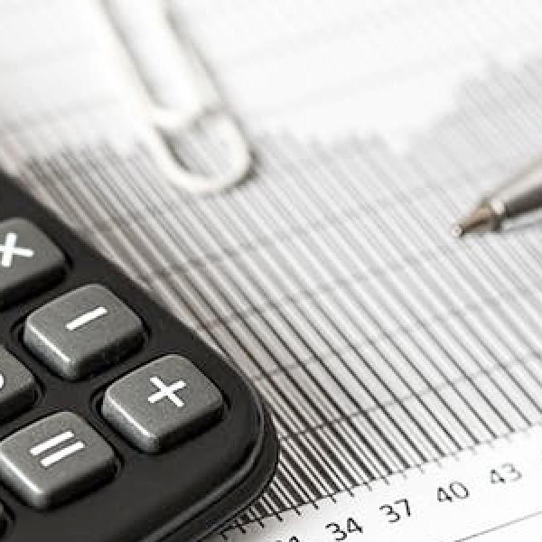 Calculator, pen, paperclip and paper