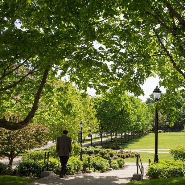 Professor walking to 87 field in Spring